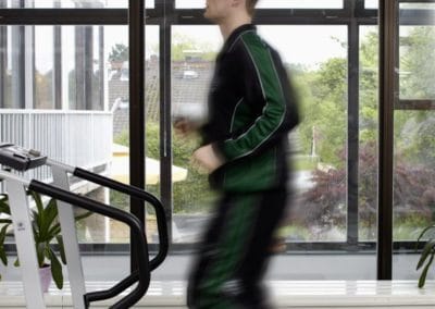 Man running on treadmill for physiotherapy