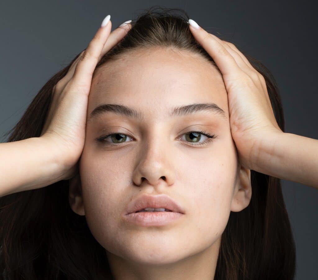 girl showing headache caused by lyme disease jaw pain